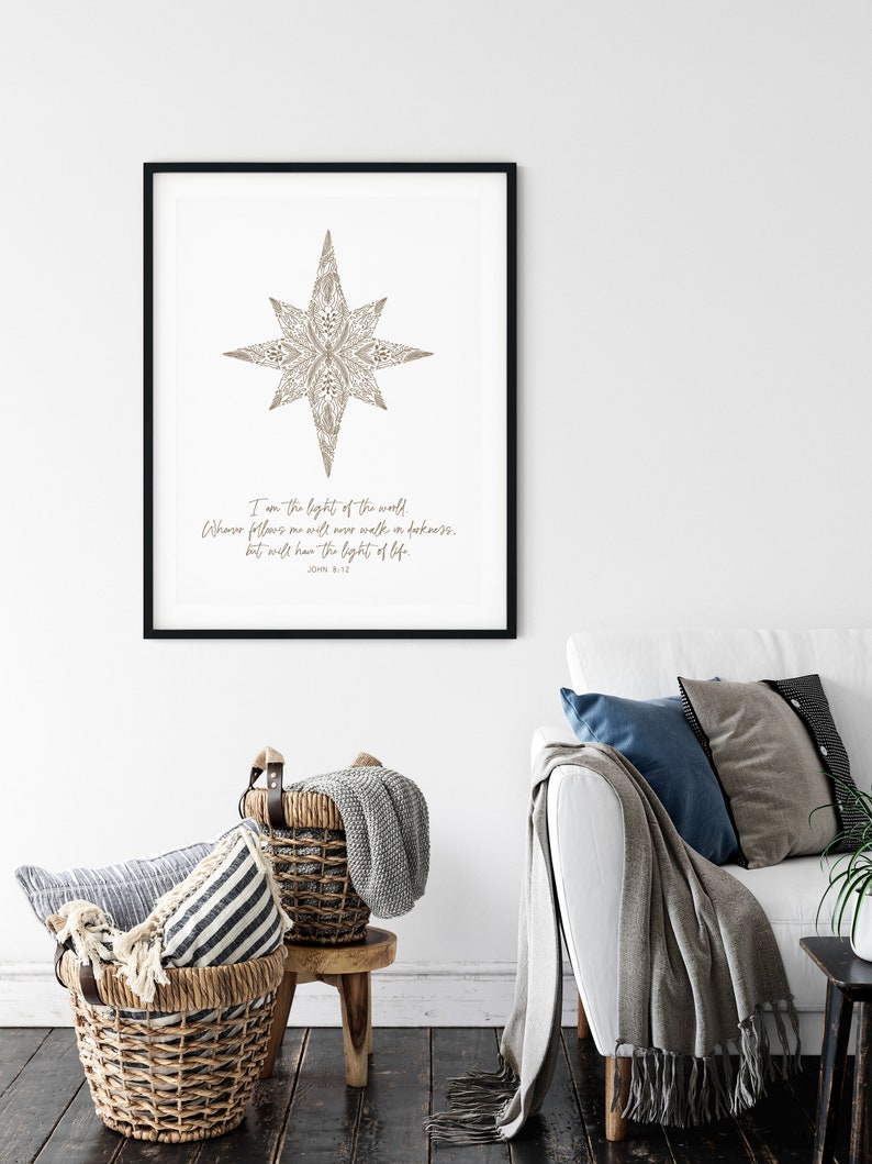 May include: A printable wall art design featuring a stylized star with a floral pattern in brown. The text "I am the light of the world. Whoever follows me will never walk in darkness, but will have the light of life. John 8:12" is printed below the star.
