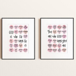 May include: Two framed prints with pink watercolor backgrounds and black calligraphy. The left print says "GOD is who He says He is" with a list of words and scripture references. The right print says "You are who GOD says you are" with a list of words and scripture references.