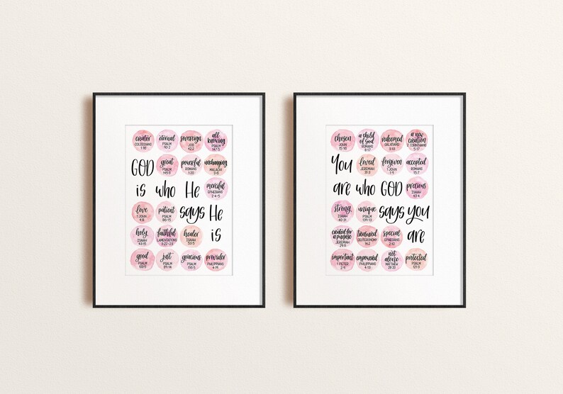 May include: Two framed prints with pink watercolor backgrounds and black calligraphy. The left print says "GOD is who He says He is" with a list of words and scripture references. The right print says "You are who GOD says you are" with a list of words and scripture references.