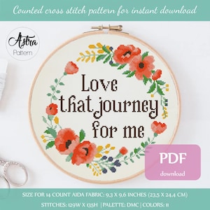 May include: Cross stitch pattern featuring a floral wreath with red flowers and green leaves surrounding the text "Love that journey for me". The pattern is designed for 14 count Aida fabric and measures 9.3 inches by 9.6 inches (23.5 cm by 24.4 cm).