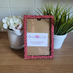 May include: A black picture frame with a pink and black ladybug design. The frame has a brown mat and a white card with the text "Jenny Wren Craft Handmade with Love" and contact information.