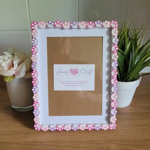 May include: White picture frame with a pink and purple paw print border. The frame has a brown mount and a white background. The text "Jenny Wren Craft Handmade with Love" is printed on a white card inside the frame. The website addresses "etsy.com/shop/JennyWrenCraftUK", "facebook.com/JennyWrenCraftUK", and "www.instagram.com/your.gifts" are also printed on the card.