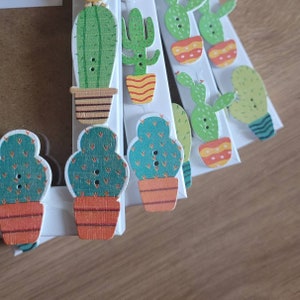 May include: A set of 10 colourful wooden cactus buttons with green, brown and yellow accents. The buttons are perfect for adding a touch of whimsy to crafts, clothing or home decor.