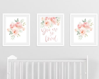 May include: Three white framed prints with pink floral designs. The center print has the text "You are so loved" in pink script.