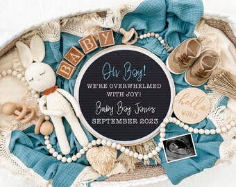 May include: A blue and white baby announcement with a round chalkboard sign that reads "Oh Boy! We're overwhelmed with joy! Baby Boy Jones September 2023". There are wooden blocks that spell out "BABY", a crocheted bunny, a wooden rattle, a pair of brown baby shoes, a wooden sign that reads "hello world", and a black and white ultrasound image.