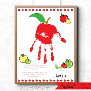 May include: Framed print featuring a red handprint shaped like an apple, with green leaf and stem. Includes apple illustrations and text: "This little apple...Lorelei." The print is a digital download.