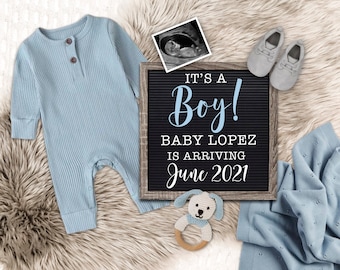 May include: A blue baby onesie, a letter board with the text "It's a Boy! Baby Lopez is arriving June 2021", a blue blanket, a pair of baby shoes, and a crocheted toy dog.