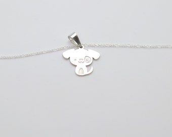 May include: A silver chain necklace with a small, silver charm in the shape of a cartoon dog. The dog has a black nose and eyes, and a small tail.