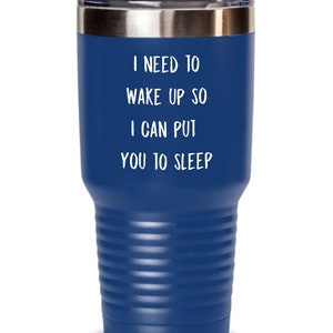 May include: A blue stainless steel tumbler with a white inscription that reads "I need to wake up so I can put you to sleep."
