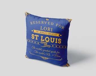 May include: Blue throw pillow with gold text that reads "Reserved for Lori The World's Greatest St. Louis Fan The world's greatest sports fan. The world's No. 1 Mom."