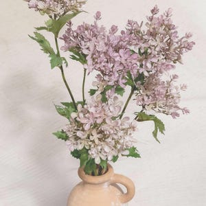 May include: A rustic wooden sign with the text "Welcome to our home" in white lettering. The sign features a distressed finish and a simple, inviting design, perfect for front door decor.