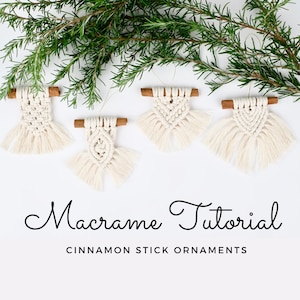 May include: Five small macrame ornaments hanging from cinnamon sticks. The ornaments are white and have a fringe at the bottom. The ornaments are arranged in a row on a white background. The text "Macrame Tutorial Cinnamon Stick Ornaments" is below the ornaments.