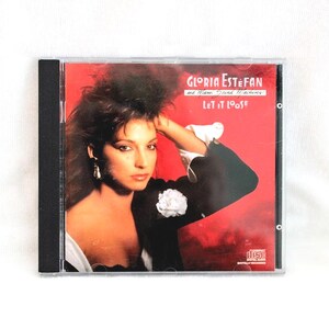 May include: CD case featuring Gloria Estefan and Miami Sound Machine's album, "Let It Loose." The cover art showcases a woman with dark hair and a black jacket against a red backdrop. The CD case is in a clear plastic case.