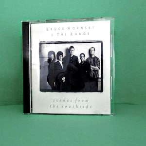 May include: A CD case featuring the album "Scenes from the Southside" by Bruce Hornsby & The Range. The cover displays a black and white photo of the band members. The text "Bruce Hornsby & The Range" and "scenes from the southside" are visible.