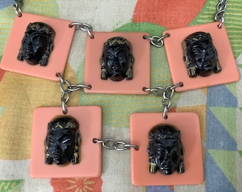 Vintage 1920s celluloid necklace Art Deco carved plastic goddess Egyptian style salmon pink novelty faces
