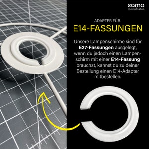 Peut inclure: Adaptateur en plastique blanc pour convertir un abat-jour E27 en abat-jour E14. L'adaptateur est présenté sur un fond quadrillé. Le texte "ADAPTER FÜR E14-FASSUNGEN" est visible sur l'image.