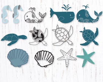 May include: A collection of sea-themed SVG designs featuring seahorses, whales, turtles, seashells, and starfish in shades of blue and black. The designs are displayed on a white wooden background. The text "Lynda M. Metcalf SVG Design" is at the bottom.