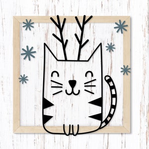 May include: A black and white illustration of a cat with antlers. The cat is sitting with its paws tucked under its body. The background is a light blue with snowflakes.