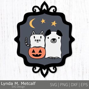 May include: A Halloween-themed graphic featuring a white cat and dog dressed as ghosts, standing next to an orange jack-o'-lantern. The design includes a crescent moon and stars, set within a decorative black frame. The text "Lynda M. Metcalf SVG Design" is at the bottom.