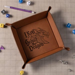 May include: A brown leather dice tray with a dragon design and the text "I Roll to Seduce the Dragon".