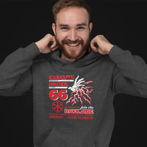 May include: A dark gray hooded sweatshirt with a red graphic print of a hand with lightning bolts and the text "Execute Order 66" and "Join the Dark Side Fear leads to anger, anger leads to hate, and hate... leads to power".