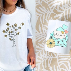 May include: A white t-shirt with a floral design and a white mug with a blue envelope and the text "I love you xo" on it.