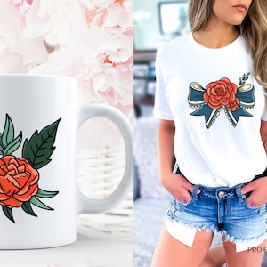 May include: A white ceramic mug with a red and green floral design. The design features a large red rose with green leaves and a smaller red rose bud.