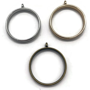 May include: Three round metal pendant frames, one silver, one gold, and one bronze. Each frame has a loop at the top for hanging.