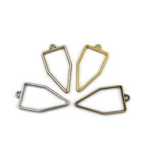 May include: Four metal pendant trays in different shapes and sizes. Two are gold, one is silver, and one is a darker bronze color.