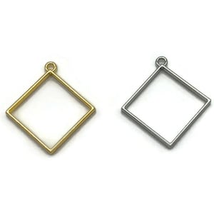 May include: Two square metal frames for jewelry making. One frame is gold and the other is silver.