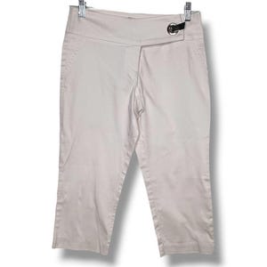 May include: Off-white capri pants featuring a wide waistband with a silver-toned metal ring detail on the right side. These pants have a clean, straight-leg cut that ends below the knee, a front zipper fly, and side pockets for a functional design.
