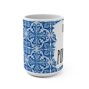 May include: White ceramic mug with a blue and white patterned design. The pattern is reminiscent of traditional Portuguese tiles. The text "I'd rather be in Portugal" is written in black on the mug.