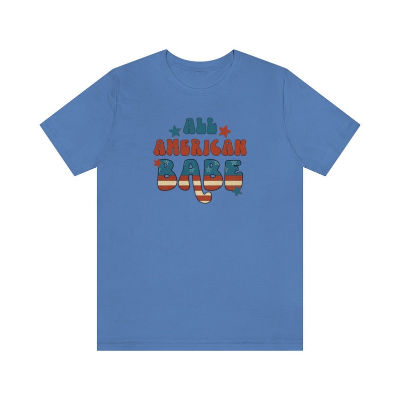 May include: A light blue t-shirt with the text "All American Babe" in red, white and blue with a star design.
