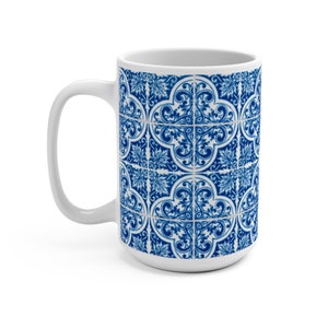 May include: White ceramic mug with a blue and white patterned design. The pattern features a repeating geometric design with intricate details.