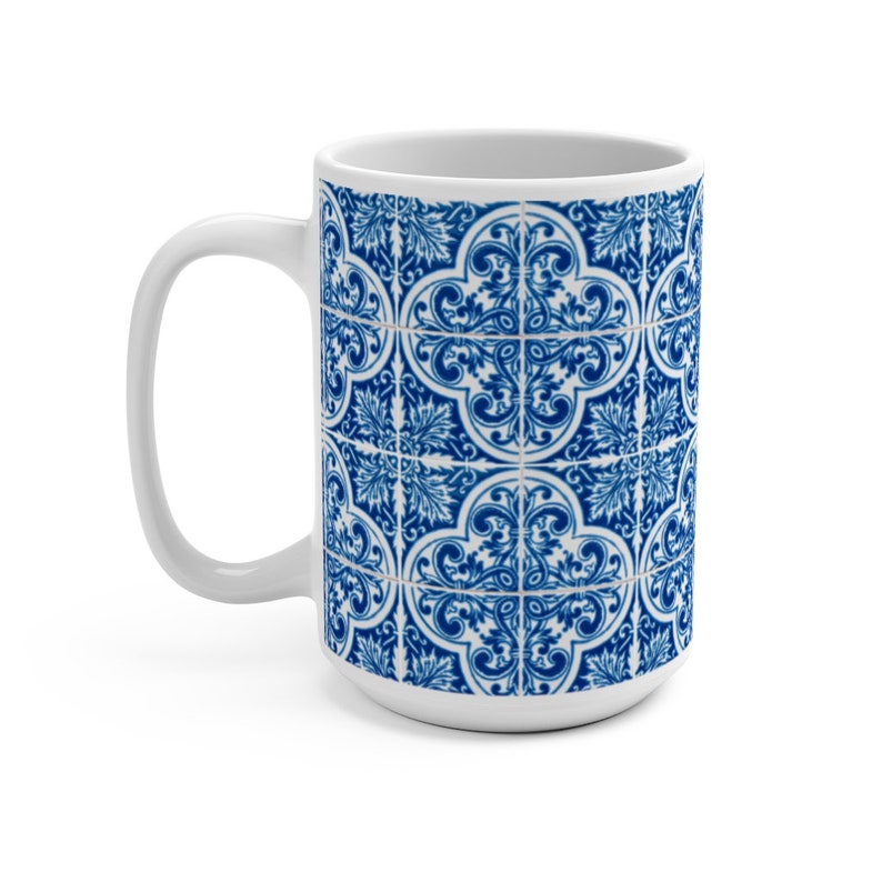 May include: White ceramic mug with a blue and white patterned design. The pattern features a repeating geometric design with intricate details.