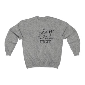 May include: A heather gray sweatshirt with the text "stay at home mom" in black script.