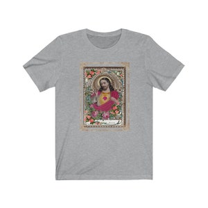 May include: A grey t-shirt with a vintage image of Jesus Christ in a gold frame with pink roses. The image has the word "Jesus" at the bottom.