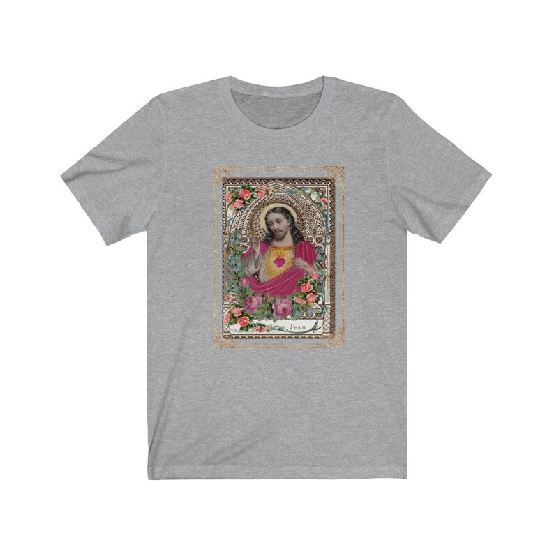 May include: A grey t-shirt with a vintage image of Jesus Christ in a gold frame with pink roses. The image has the word "Jesus" at the bottom.