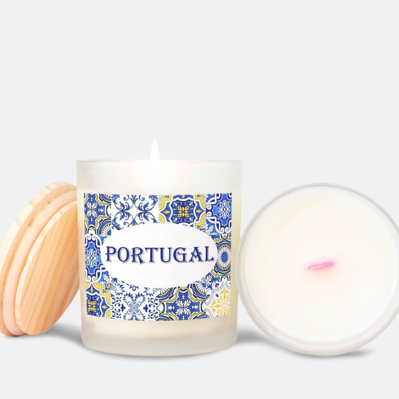 May include: A white frosted glass candle jar with a blue and yellow patterned label that says "PORTUGAL". The candle jar has a wooden lid.