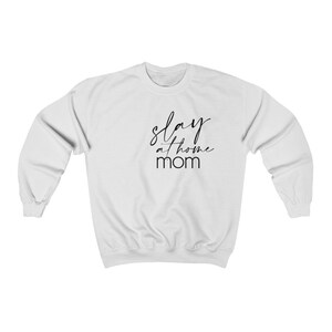 May include: White sweatshirt with black text that reads "slay at home mom".