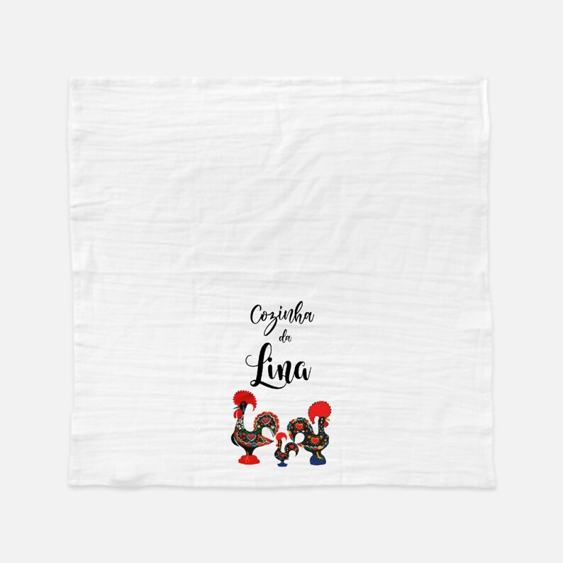 May include: White kitchen towel with black text that reads "Cozinha da Lina" and two colorful rooster illustrations.