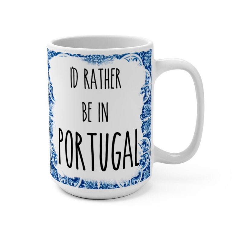 May include: White ceramic mug with a blue and white patterned design. The mug features the text "I'd rather be in Portugal".