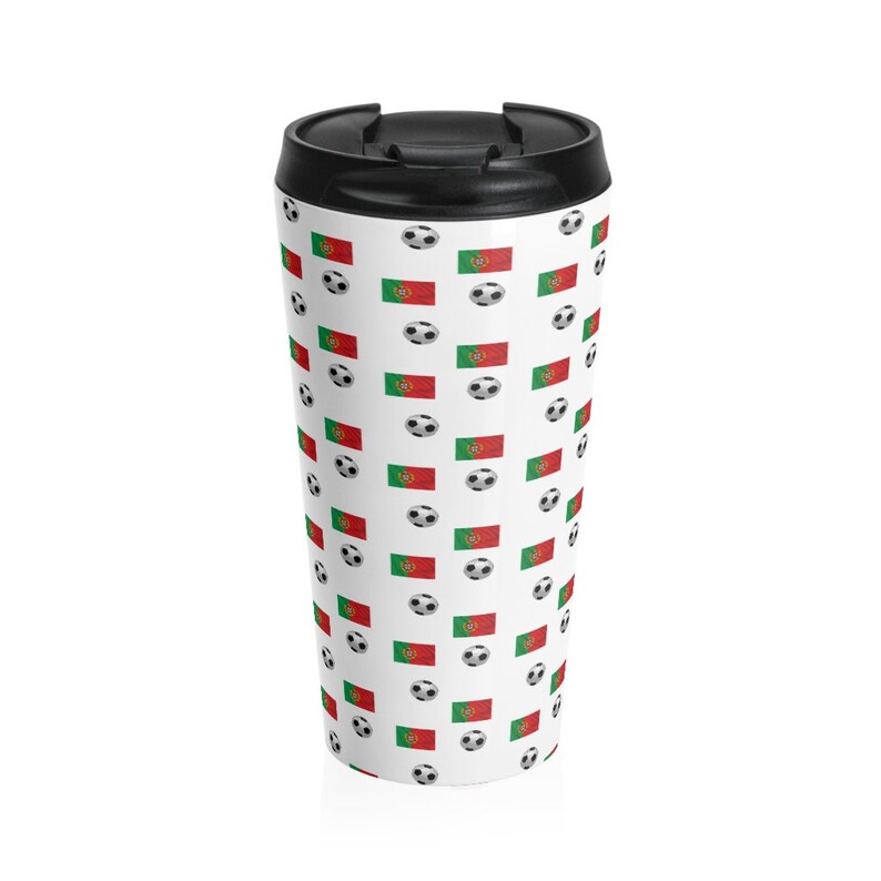 May include: A white travel mug with a black lid and a pattern of soccer balls and the Portuguese flag.
