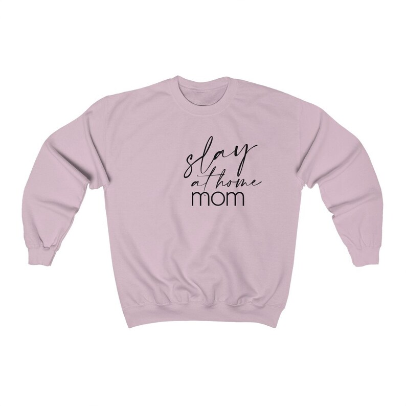 May include: A light pink sweatshirt with the text "slay at home mom" in black script.