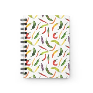 May include: Spiral-bound notebook with a white cover featuring a watercolor pattern of colorful chili peppers. The peppers are in shades of red, green, yellow, orange, and purple, scattered across the cover.