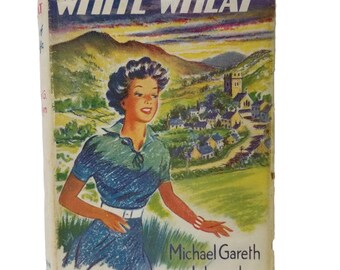 May include: A vintage hardcover book titled White Wheat by Michael Gareth Llewelyn. The cover features a colorful illustration of a person in a blue dress standing in a field with a village and mountains in the background under a dark sky.