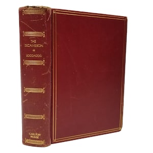 May include: A vintage hardcover book titled "The Decameron" by Boccaccio. The book has a deep red cover with gold trim and lettering. The spine is also red with gold decorative elements and the publisher's name, "Carlton House."