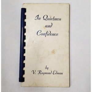 May include: A rectangular softcover book titled In Quietness and Confidence by V. Raymond Edman. The cover is off-white with dark blue text and a dark blue plastic spiral binding along the left edge. The paper shows signs of age and light staining.