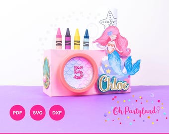 May include: A pink and blue mermaid-themed activity box template for playdoh and crayons. The box has a mermaid illustration, a starfish, and a circle with the number 5. The text "Chloe" and "Oh Partyland?" are also included.