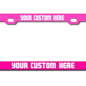 May include: A pink metal license plate frame with white text that reads "YOUR CUSTOM HERE" on the top and bottom.